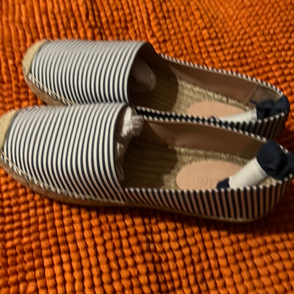 Blue stripe espadrilles with ankle strap.